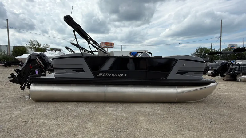 Slide: The Image of A modern Starcraft VX 20 Q DH pontoon boat, model year 2027, sits on a gravel lot. - 9