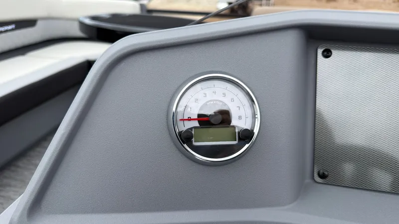 Slide: The Image of Close-up of a gray dashboard featuring an analog speedometer and digital display. - 35