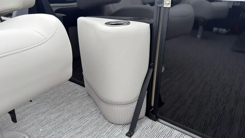 Slide: The Image of A sleek cup holder in a modern boat with gray carpeting and black walls. - 30