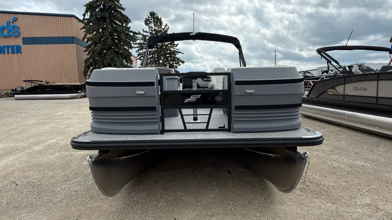 Slide: The Image of A gray Starcraft VX 20 Q DH pontoon boat is on a gravel lot. It features a modern design. - 11