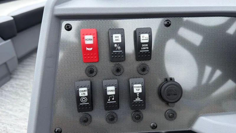 Slide: The Image of Close-up of a boat control panel with various switches, including horn, navigation lights, and dock lights. - 34