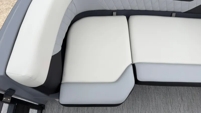Slide: The Image of The image shows a sleek, cushioned seating area with light gray and white upholstery on a boat. - 17
