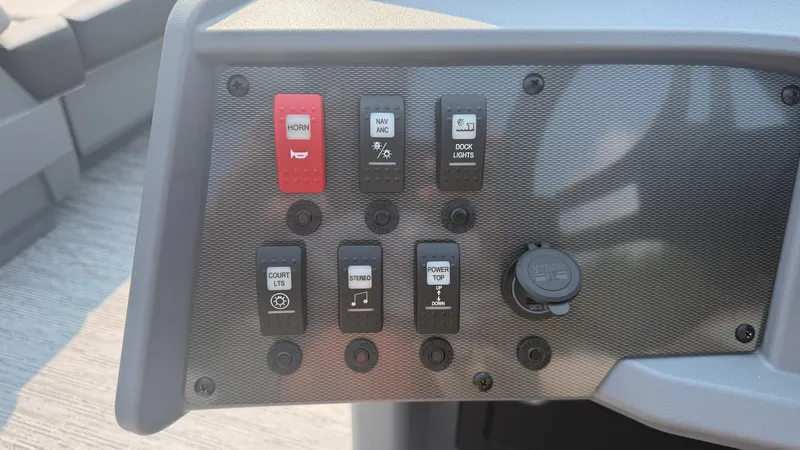 Slide: The Image of Dashboard of the 2027 Starcraft VX 20 R DH with switches for horn, lights, and stereo. - 26