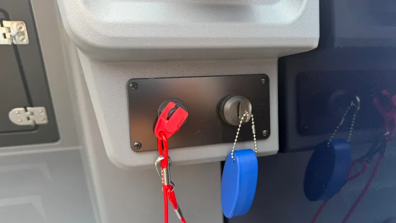 Slide: The Image of Close-up of a boat control panel with red and blue keys on chains. - 33