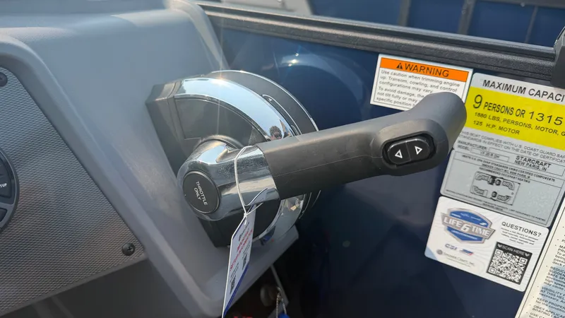 Slide: The Image of Close-up of a throttle lever with warning labels and capacity information. - 31