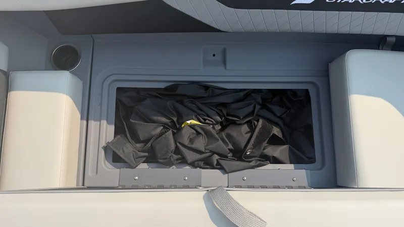 Slide: The Image of A storage compartment on a Starcraft VX 20 R DH boat with a black cover inside. - 19