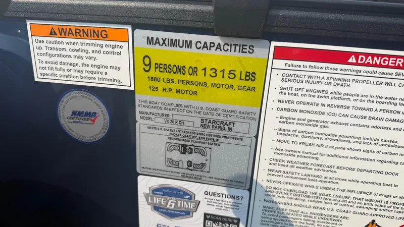 Slide: The Image of Safety and capacity labels for a 2027 Starcraft VX 20 R DH boat. - 32