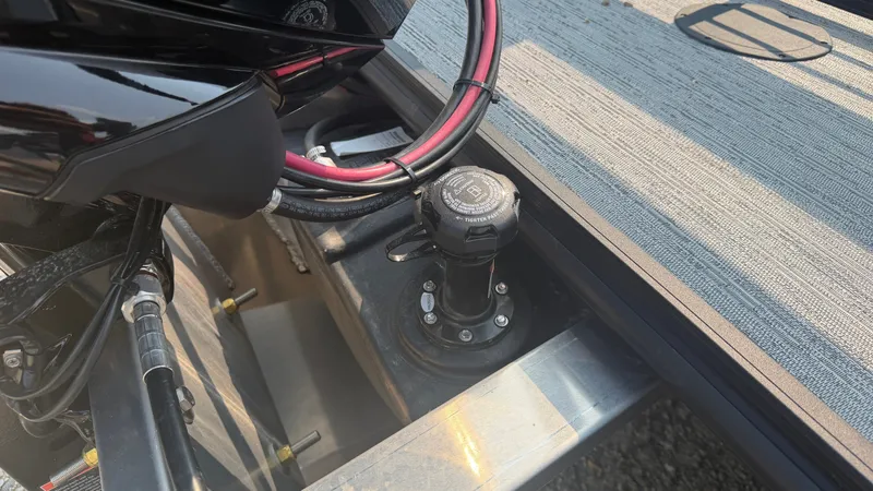 Slide: The Image of Close-up of a boat deck area with cables and a fuel cap. - 48