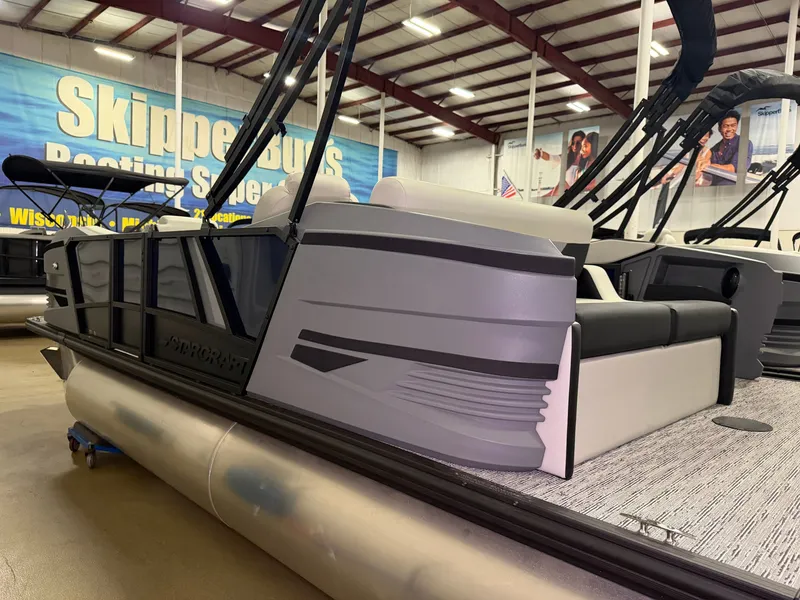 Slide: The Image of A modern pontoon boat with gray and black accents is situated in a showroom. - 3