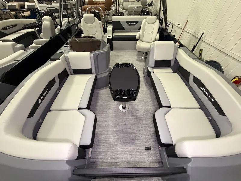 Slide: The Image of The image shows the interior of a Starcraft VX 20 Q DH boat with sleek white seating. - 4
