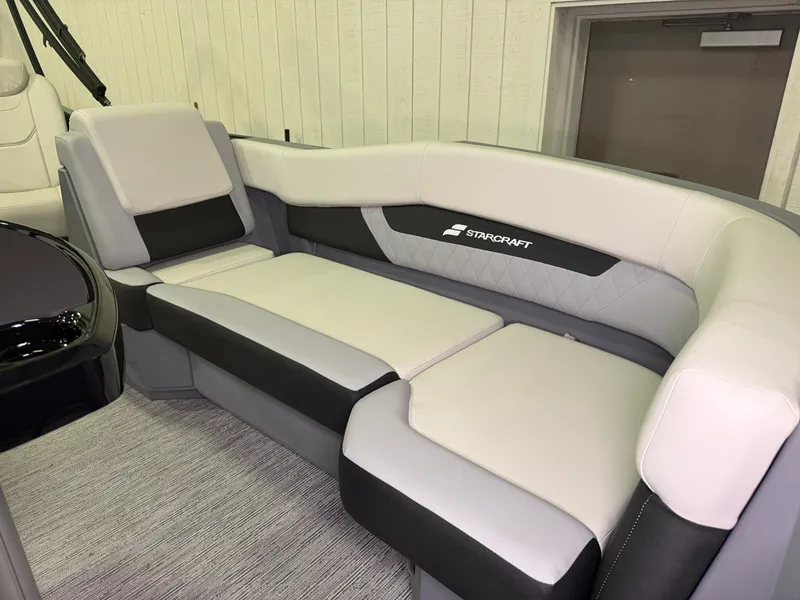 Slide: The Image of The interior of the 2027 Starcraft VX 20 Q DH features an elegant, cushioned seating area. - 10
