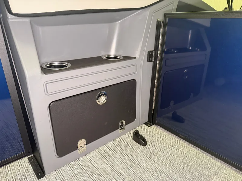 Slide: The Image of Interior of a Starcraft VX 20 Q DH with gray storage and cup holders. - 26