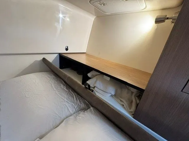 Slide: The Image of Interior of 2016 Boston Whaler 315 Conquest with bed and storage space. - 27