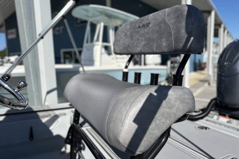 Slide: The Image of 2026 Avid 20 Rogue CC boat seat and steering wheel in a marina setting. - 10