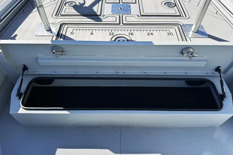 Slide: The Image of Open storage compartment on 2026 Avid 20 Rogue CC boat deck. - 20
