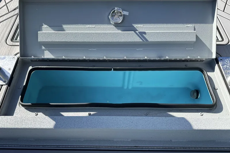 Slide: The Image of Open storage compartment on 2026 Avid 20 Rogue CC boat, featuring a sleek design. - 23