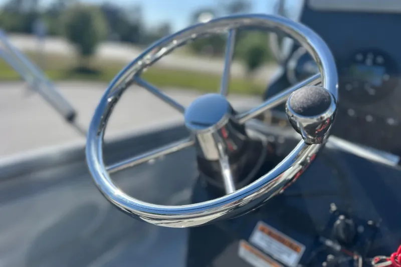 Slide: The Image of Close-up of a shiny steering wheel on a 2026 Avid 20 Rogue CC boat. - 24