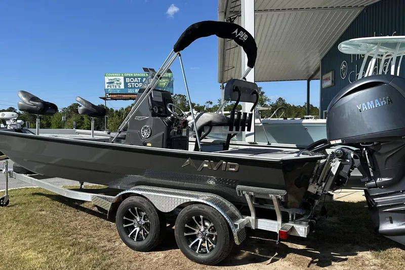 Slide: The Image of 2026 Avid 20 Rogue CC boat on trailer with Yamaha engine, parked outdoors. - 6