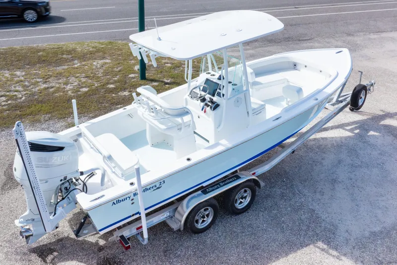 Slide: The Image of 2026 Albury Brothers 23 Forward Seating boat on trailer, featuring Suzuki outboard motor. - 10