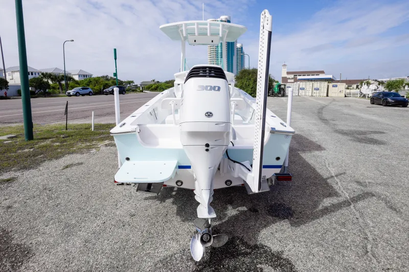Slide: The Image of 2026 Albury Brothers 23 Forward Seating boat with powerful outboard motor, parked outdoors. - 12