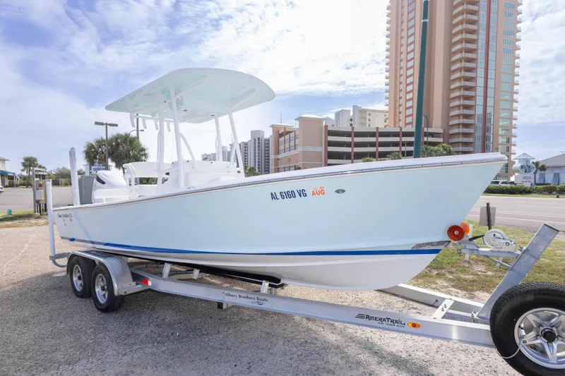 Slide: The Image of 2026 Albury Brothers 23 Forward Seating boat on trailer, urban backdrop. - 15