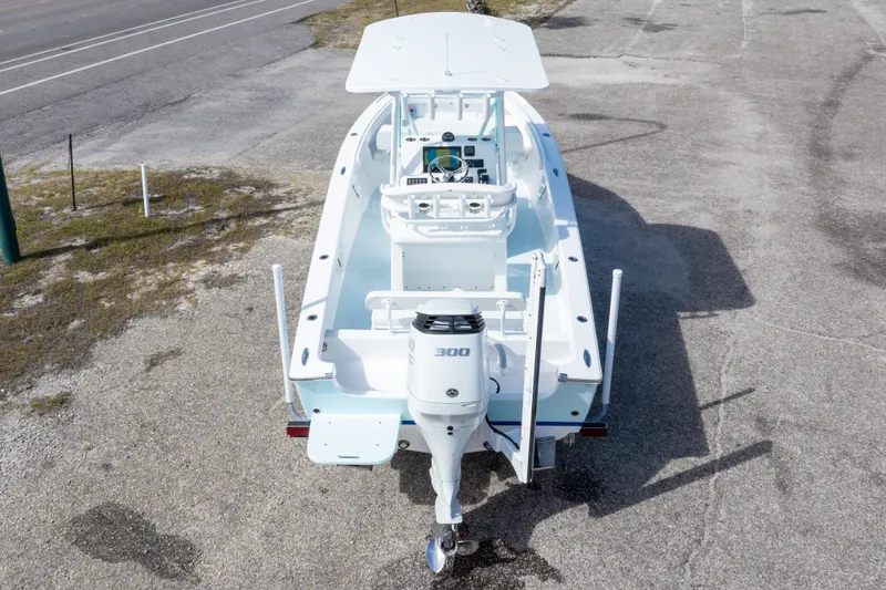 Slide: The Image of 2026 Albury Brothers 23 Forward Seating boat with powerful outboard motor, parked on concrete. - 19