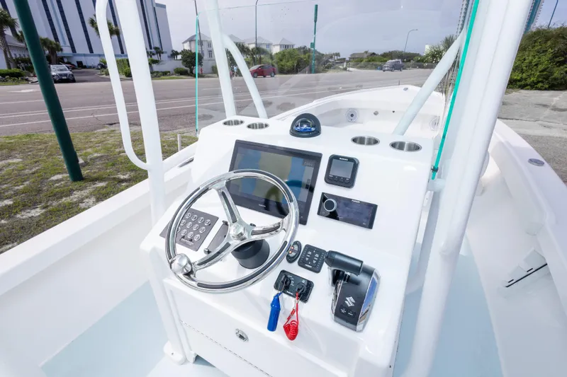 Slide: The Image of 2026 Albury Brothers 23 Forward Seating boat dashboard with steering wheel and navigation controls. - 21