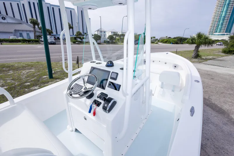 Slide: The Image of 2026 Albury Brothers 23 Forward Seating boat with modern helm and coastal backdrop. - 23