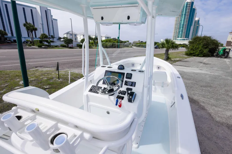 Slide: The Image of 2026 Albury Brothers 23 Forward Seating boat with modern console and urban backdrop. - 24