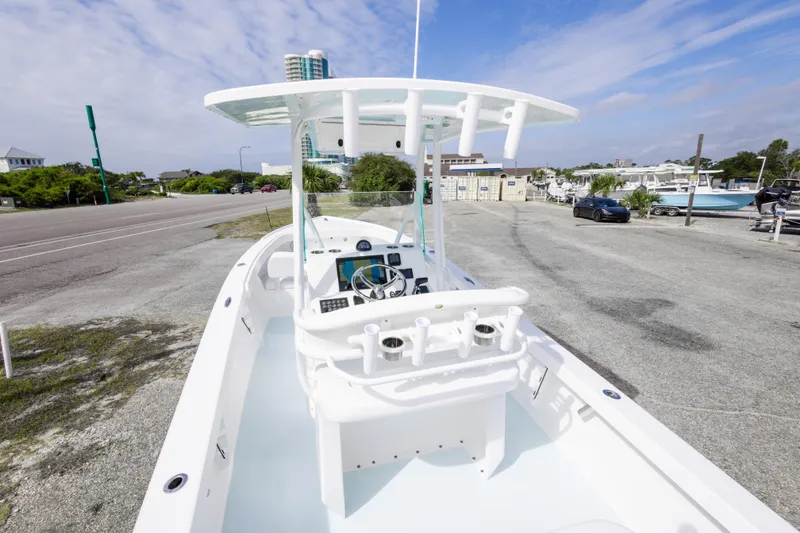 Slide: The Image of 2026 Albury Brothers 23 Forward Seating boat parked near a marina under a clear sky. - 26