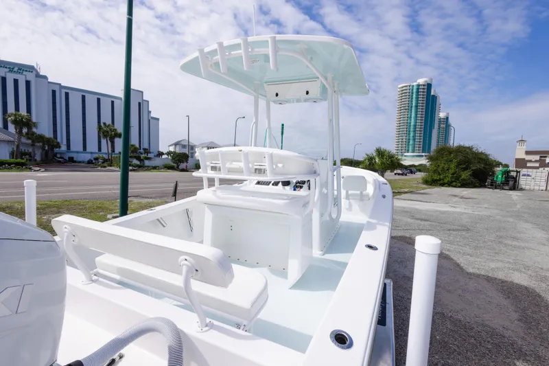 Slide: The Image of 2026 Albury Brothers 23 Forward Seating boat docked near modern buildings under a blue sky. - 27