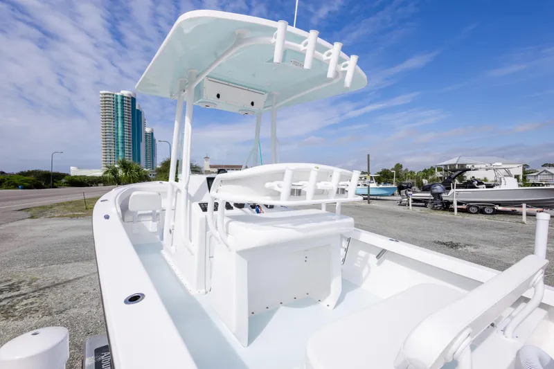 Slide: The Image of 2026 Albury Brothers 23 Forward Seating boat with sleek design, parked near waterfront buildings. - 28