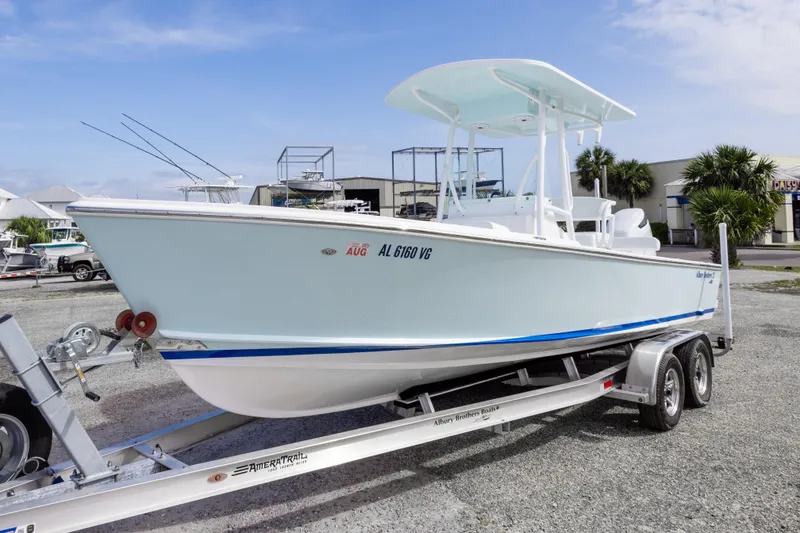 Slide: The Image of 2026 Albury Brothers 23 Forward Seating boat on trailer, parked outdoors under blue sky. - 3