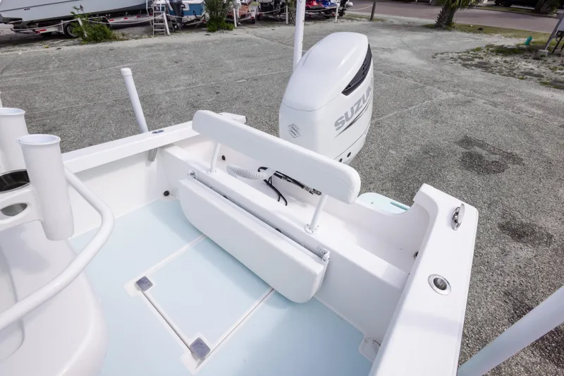 Slide: The Image of 2026 Albury Brothers 23 Forward Seating boat with Suzuki outboard motor, docked on gravel. - 30