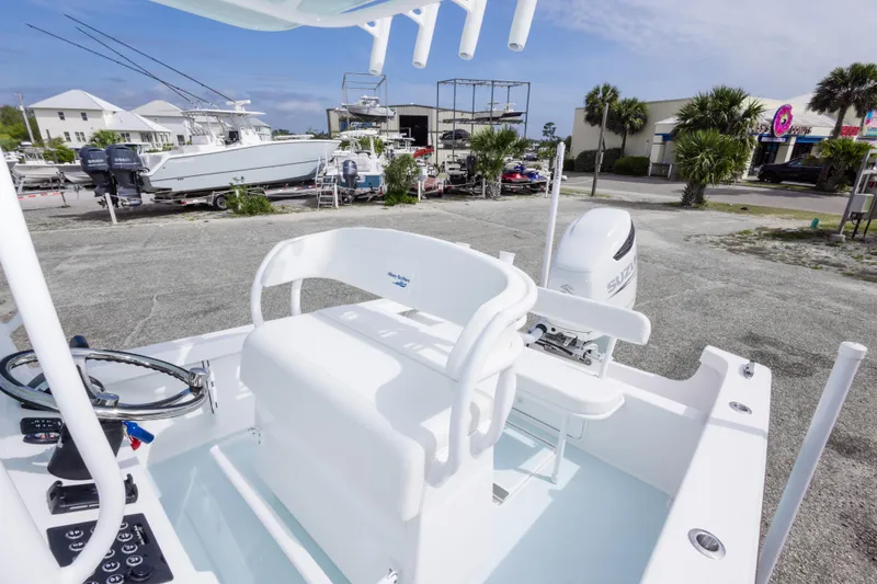 Slide: The Image of 2026 Albury Brothers 23 Forward Seating boat with Suzuki outboard motor in a marina setting. - 32