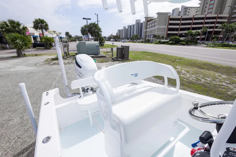 Slide: The Image of 2026 Albury Brothers 23 Forward Seating boat with Suzuki engine, parked near a road. - 33