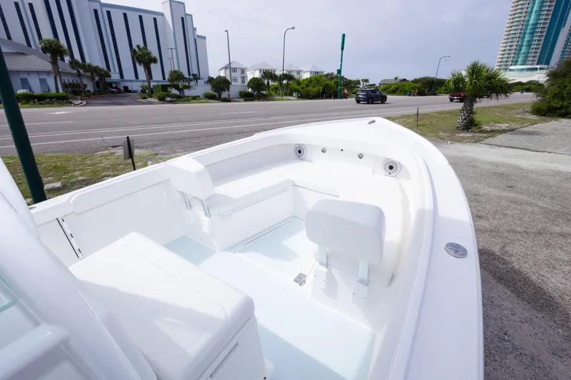 Slide: The Image of 2026 Albury Brothers 23 Forward Seating boat parked near a coastal road. - 34