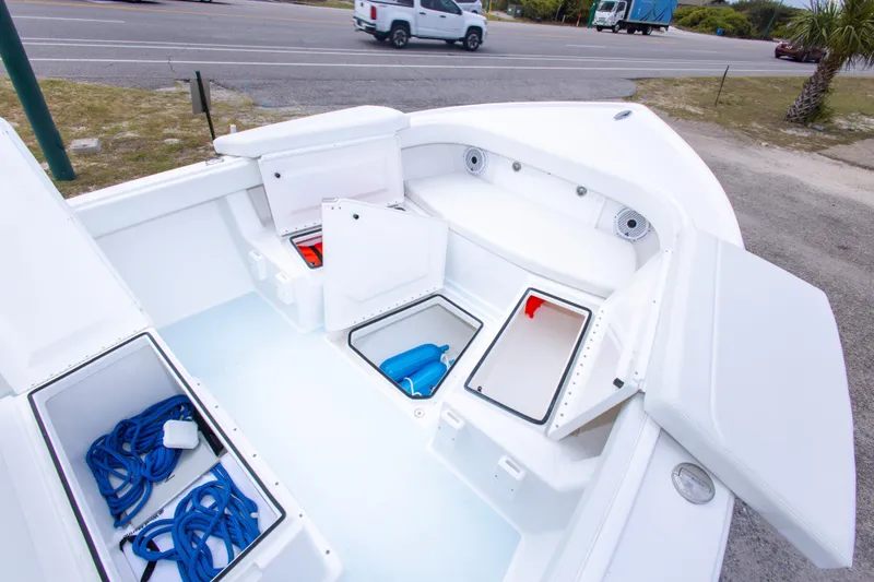 Slide: The Image of 2026 Albury Brothers 23 Forward Seating boat with open storage compartments and visible blue ropes. - 39