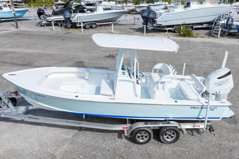 Slide: The Image of 2026 Albury Brothers 23 Forward Seating boat on trailer, featuring Suzuki outboard motor. - 7