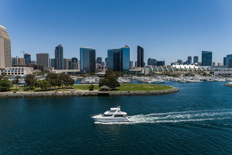 Slide: The Image of 1999 Carver 530 Voyager Pilothouse cruising near city skyline and marina. - 13
