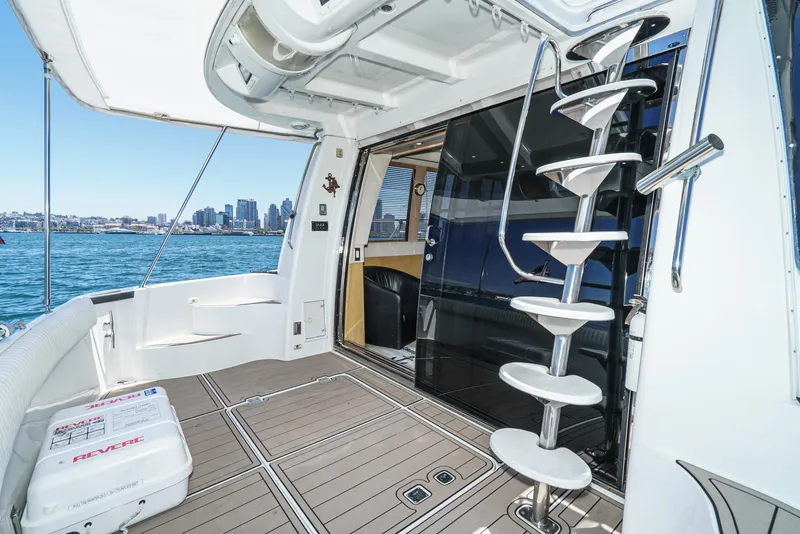 Slide: The Image of 1999 Carver 530 Voyager Pilothouse yacht interior with spiral staircase and city skyline view. - 15