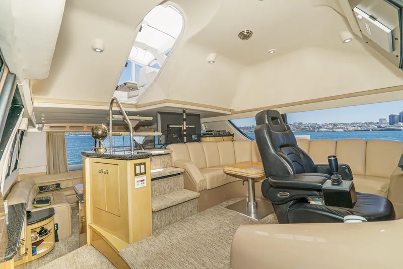 Slide: The Image of Luxurious interior of 1999 Carver 530 Voyager Pilothouse yacht with leather seating and panoramic views. - 18