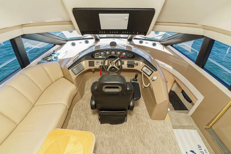 Slide: The Image of 1999 Carver 530 Voyager Pilothouse helm with luxurious seating and modern controls. - 19