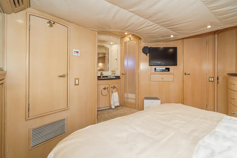 Slide: The Image of Interior of 1999 Carver 530 Voyager Pilothouse with TV, wood paneling, and bathroom access. - 22