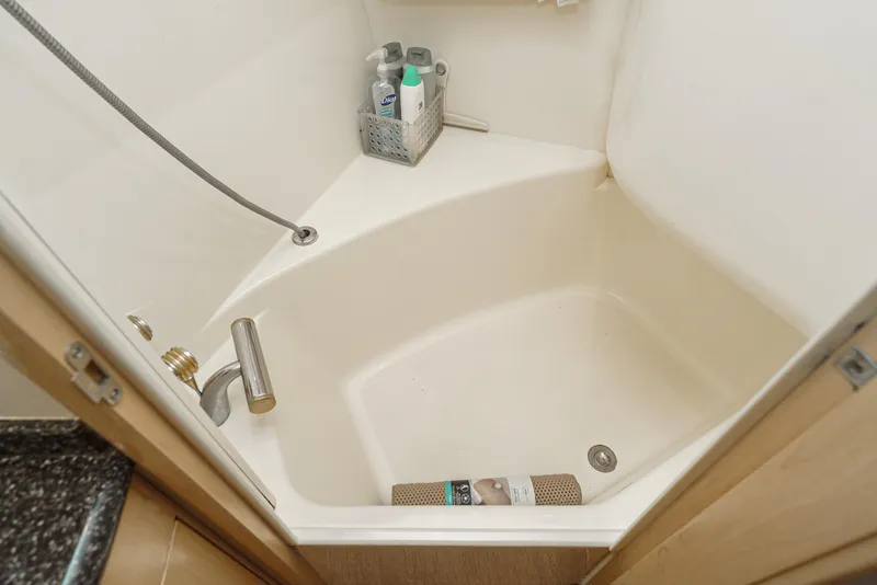 Slide: The Image of Shower area in 1999 Carver 530 Voyager Pilothouse with toiletries and handheld showerhead. - 23