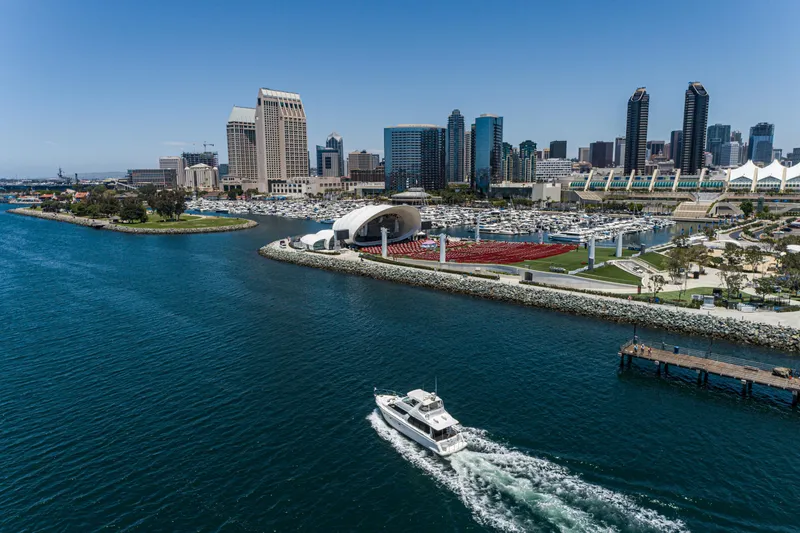 Slide: The Image of 1999 Carver 530 Voyager Pilothouse cruising near San Diego skyline and marina. - 29
