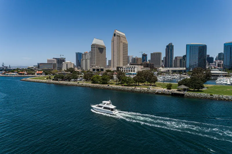 Slide: The Image of 1999 Carver 530 Voyager Pilothouse cruising near city skyline and waterfront park. - 32