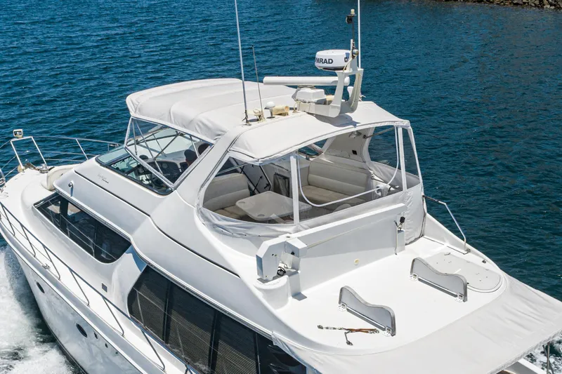 Slide: The Image of 1999 Carver 530 Voyager Pilothouse yacht cruising on blue ocean waters. - 34