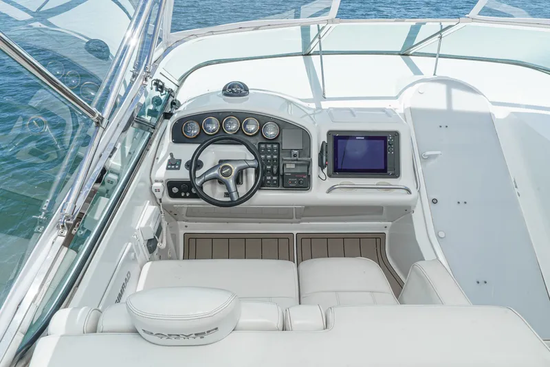 Slide: The Image of 1999 Carver 530 Voyager Pilothouse helm with steering wheel and navigation instruments. - 36