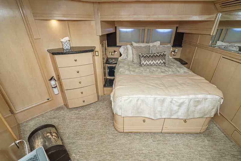 Slide: The Image of Luxurious bedroom in 1999 Carver 530 Voyager Pilothouse yacht with elegant decor and cozy bedding. - 41
